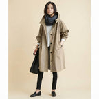 Front view of the Angelika oversized hooded trench coat in beige, featuring a relaxed oversized silhouette, attached hood, long sleeves, and practical front pockets.