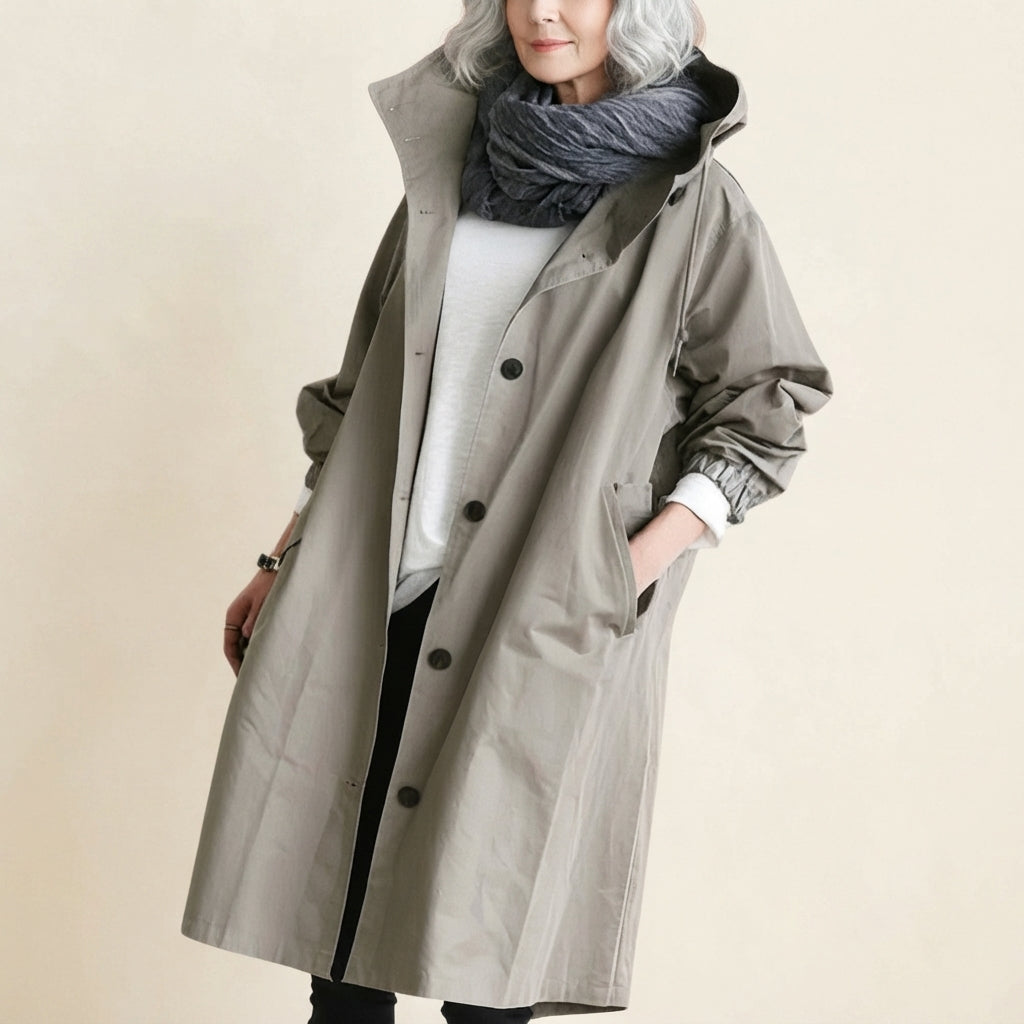 Front view of the Angelika oversized hooded trench coat in grey, featuring a relaxed oversized silhouette, attached hood, long sleeves, and practical front pockets.