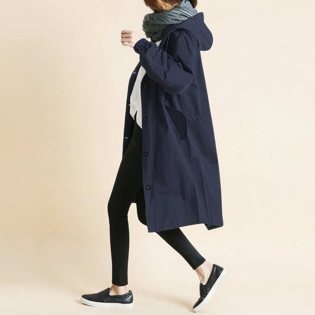 Front view of the Angelika oversized hooded trench coat in navy blue, featuring a relaxed oversized silhouette, attached hood, long sleeves, and practical front pockets.