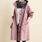 Front view of the Angelika oversized hooded trench coat in pink, featuring a relaxed oversized silhouette, attached hood, long sleeves, and practical front pockets.