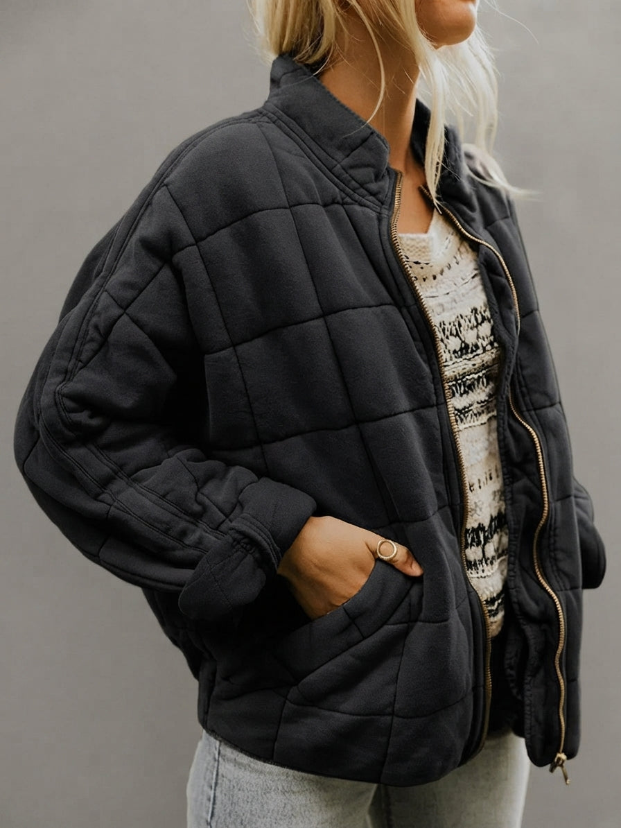 Front view of the Anouska Quilted Jacket in black, showcasing its quilted texture, oversized relaxed fit, long sleeves, and stylish everyday design.