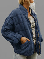 Front view of the Anouska Jacket Quilted Oversized in dark blue, showcasing its quilted texture, oversized relaxed fit, long sleeves, and stylish everyday design.