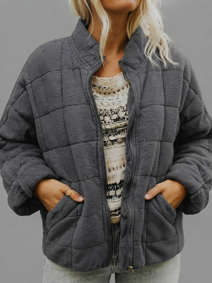 Front close-up view of the Anouska Jacket Quilted Oversized in dark grey, highlighting its quilted texture, relaxed oversized fit, and stylish front design.