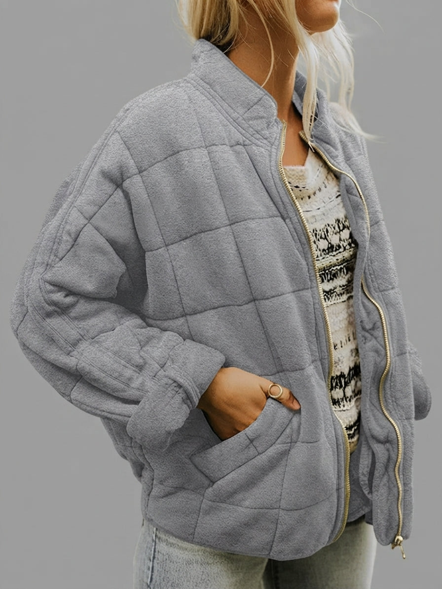 Front view of the Anouska Quilted Jacket in gray, showcasing its quilted texture, oversized relaxed fit, long sleeves, and stylish everyday design.