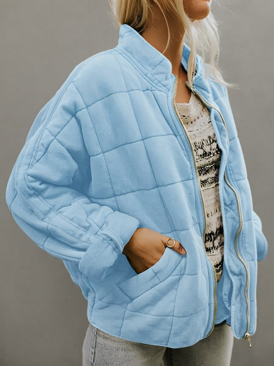 Front view of the Anouska Quilted Jacket in light blue, showcasing its quilted texture, oversized relaxed fit, long sleeves, and stylish everyday design.