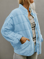 Front view of the Anouska Quilted Jacket in light blue, showcasing its quilted texture, oversized relaxed fit, long sleeves, and stylish everyday design.
