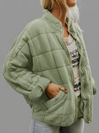 Front view of the Anouska Quilted Jacket in light green, showcasing its quilted texture, oversized relaxed fit, long sleeves, and stylish front design.