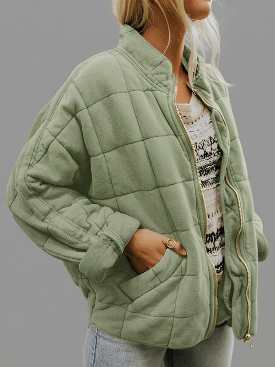 Front view of the Anouska Quilted Jacket in light green, showcasing its quilted texture, oversized relaxed fit, long sleeves, and stylish front design.