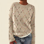 Front view of the beige Béatrix Reindeer-Print Crew-Neck Sweater featuring a festive reindeer print, classic crew neckline, long sleeves, and cozy knit fabric.