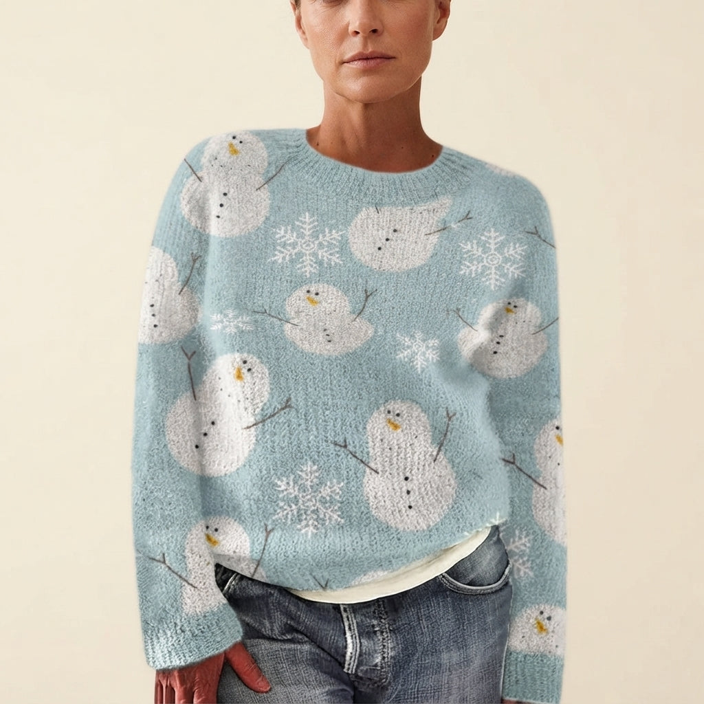Front view of the light blue Béatrix Reindeer-Print Crew-Neck Sweater featuring a festive reindeer print, classic crew neckline, long sleeves, and cozy knit fabric.
