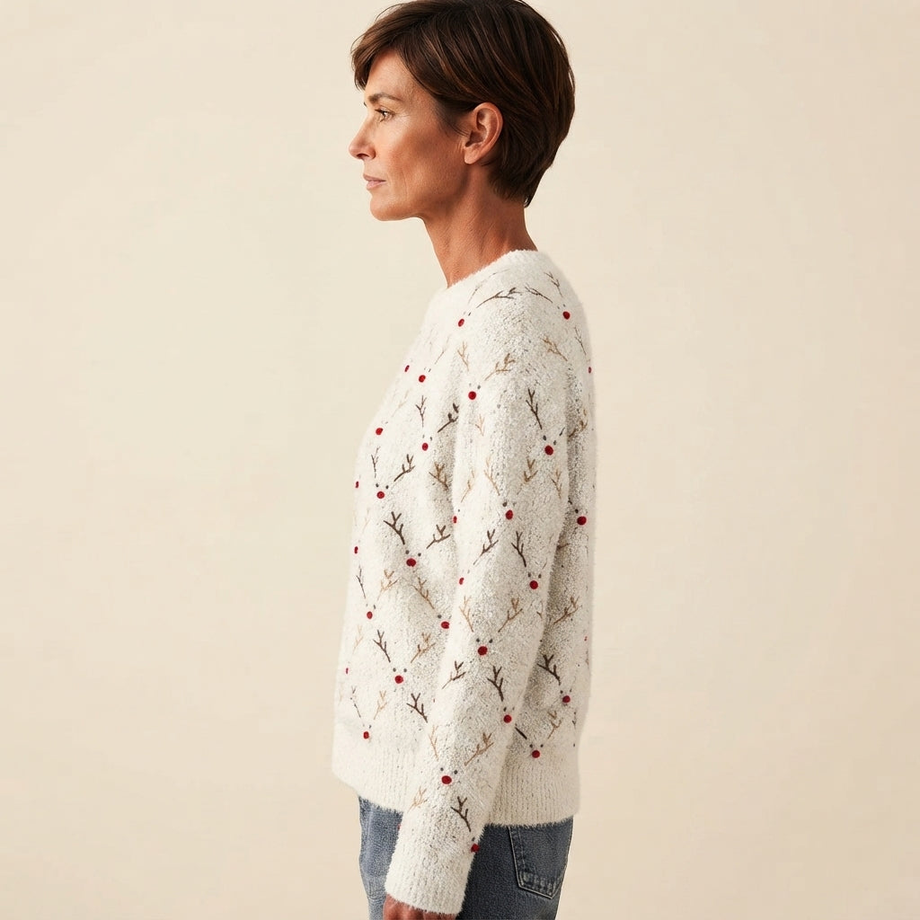 Side view of the white Béatrix Reindeer-Print Crew-Neck Sweater featuring a festive reindeer print, long sleeves, and a relaxed cozy fit.
