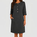 Front view of Black linen midi dress with rolled sleeves and side pockets by BELLA HUDSON
