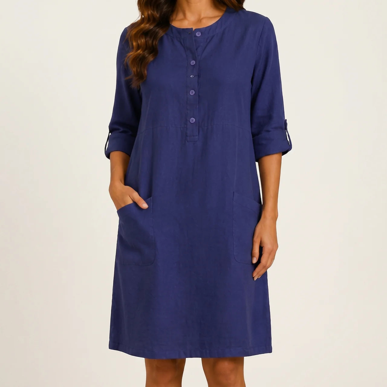 Front view of brightblue linen midi dress with rolled sleeves and side pockets by BELLA HUDSON