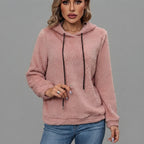 Front view of the Céleste Hoodie Sherpa Drawstring in pink, featuring soft sherpa fabric, a cozy hood, adjustable drawstring, long sleeves, and a relaxed fit.