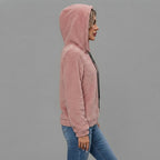 Side view of the Céleste Hoodie Sherpa Drawstring in pink, showcasing its soft sherpa texture, cozy hood, adjustable drawstring, long sleeves, and relaxed silhouette.