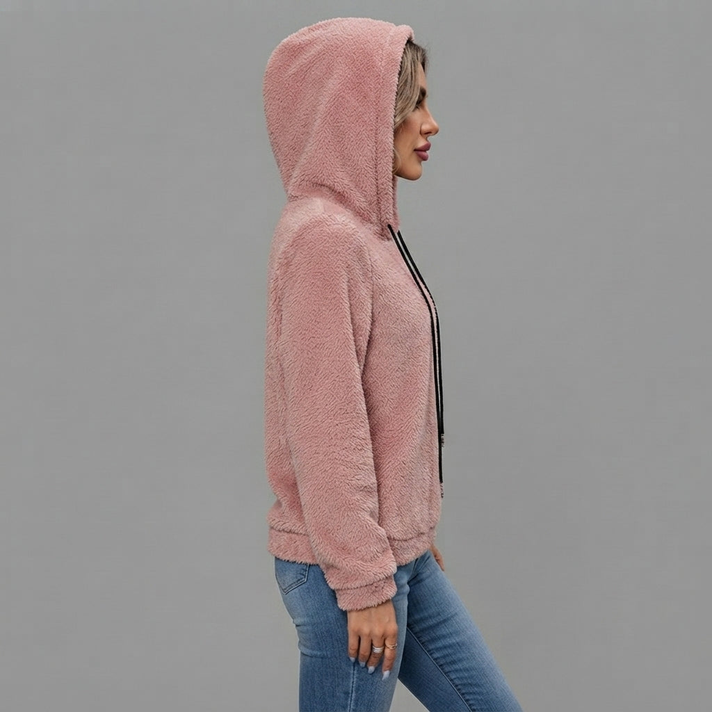 Side view of the Céleste Hoodie Sherpa Drawstring in pink, showcasing its soft sherpa texture, cozy hood, adjustable drawstring, long sleeves, and relaxed silhouette.