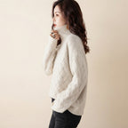 Charlotte Sweater Turtleneck Cable-Knit in cream color, side view, showcasing the cozy cable-knit texture, high turtleneck neckline, long sleeves, and relaxed fit.