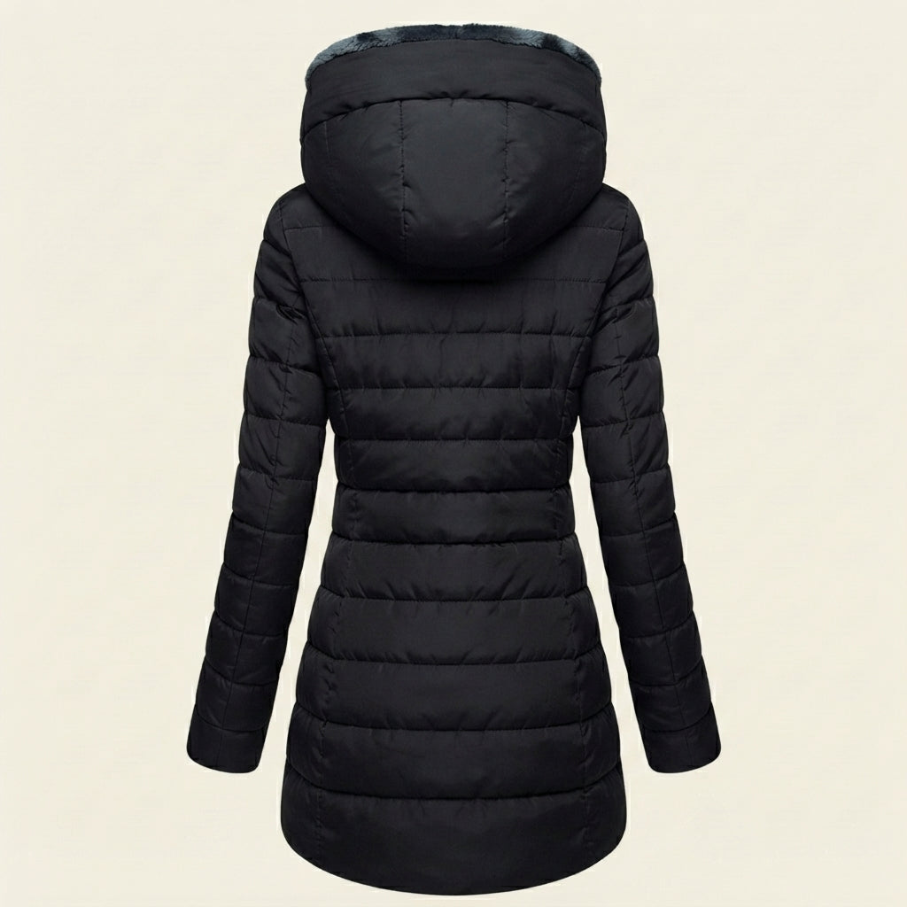 Back view showcasing the Clara puffer jacket in black, highlighting the quilted back panel, cozy faux-fur-lined hood, long sleeves, and comfortable winter-ready silhouette.