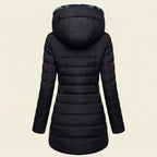 Back view showcasing the Clara puffer jacket in black, highlighting the quilted back panel, cozy faux-fur-lined hood, long sleeves, and comfortable winter-ready silhouette.