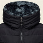 Close-up front view highlighting the Clara puffer jacket’s soft faux-fur-lined hood, quilted texture, full-zip closure, stitching details, and warm black finish.
