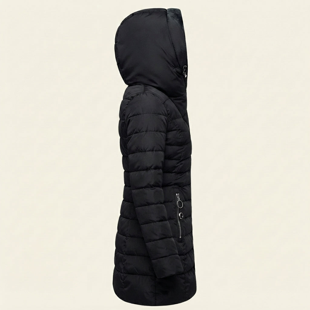 Side view showcasing the Clara puffer jacket in black, highlighting its quilted construction, faux-fur-lined hood, long sleeves, comfortable silhouette, and warm winter-ready design.