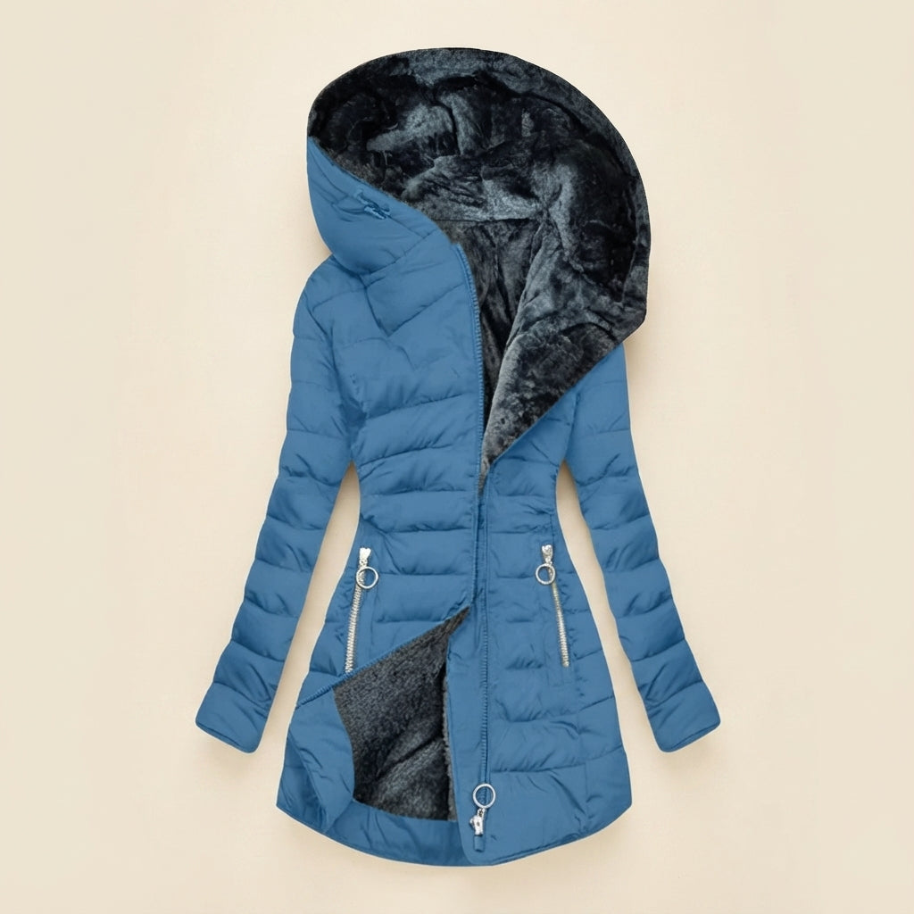 Front view showcasing the Clara puffer jacket in light blue, featuring a cozy faux-fur-lined hood, quilted body, full-zip front closure, long sleeves, and a warm, comfortable silhouette.