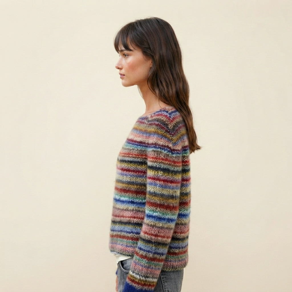 Side view of the Isaure Sweater Striped Crew-Neck featuring its multi-color striped pattern, classic crew neckline, long sleeves, and comfortable knit silhouette. The side profile highlights the relaxed shape and easy everyday fit.