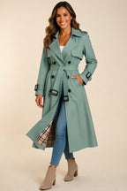 Front view highlighting the light green color, soft wool-blend fabric, structured trench coat design, long sleeves, front closure, and elegant belted waist.