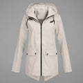 Front view of the Julia Rain Jacket Hooded Zip-Front in a soft light beige color, highlighting the hooded design, full zip-front closure, long sleeves, and clean lightweight silhouette.