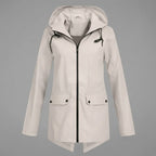 Front view of the Julia Rain Jacket Hooded Zip-Front in a soft light beige color, highlighting the hooded design, full zip-front closure, long sleeves, and clean lightweight silhouette.