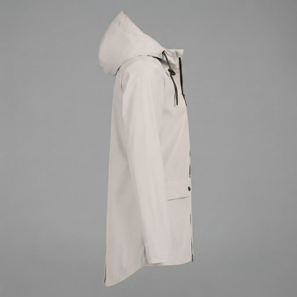 Side view of the Julia Rain Jacket featuring a soft cream color, attached hood, full zip-front closure, long sleeves, and practical front pockets. The lightweight design offers a clean, versatile look for rainy days, outdoor activities, travel, and everyday wear.