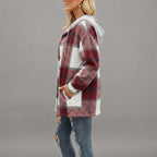 Side view of the Odalys women's red plaid flannel hooded shacket featuring a relaxed silhouette, long sleeves, cozy hood, and classic red plaid flannel design.