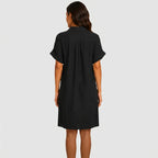 Back view of black button front midi dress with short sleeves and side pockets by BELLA HUDSON