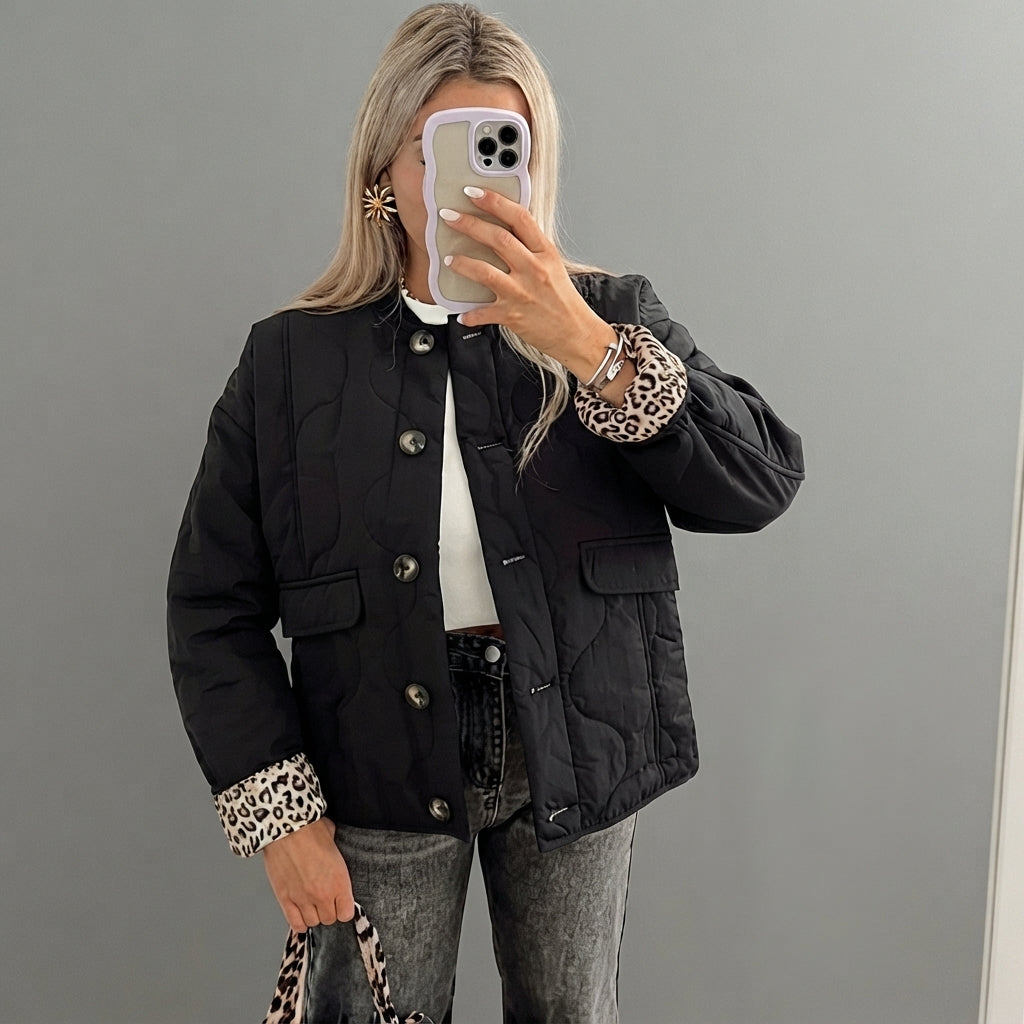 Front view of the Sylvaine Jacket Quilted Leopard-Trim in black, featuring a quilted design with stylish leopard-print trim and a comfortable everyday silhouette.