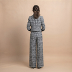 Valentina Frayed Jacket and Pants Two-Piece Set in Black shown in back view with coordinated jacket and pants.