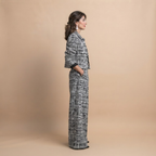 Valentina Frayed Jacket and Pants Two-Piece Set in Black shown in side view with relaxed fit and frayed-edge details.