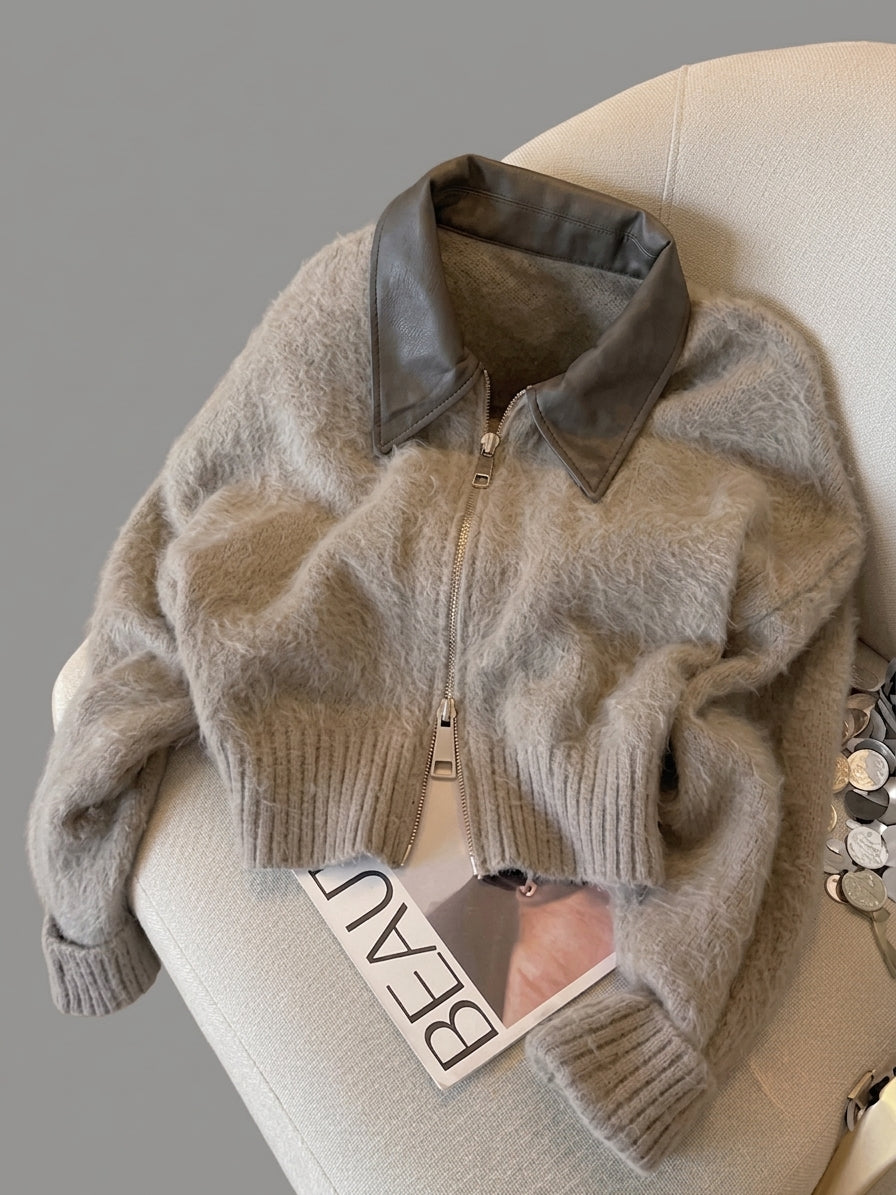Vintage Patchwork Knit Cardigan cropped zipper sweater jacket in taupe with a dark brown faux-leather collar, styled on a cream-colored armchair with a magazine underneath.