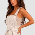 Close-up view of White striped wide leg jumpsuit with tie waist and sleeveless design by BELLA HUDSON