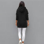 Back view of the Wilhelmine oversized side-slit hoodie in black, featuring a relaxed oversized silhouette, cozy hood, long sleeves, and comfortable casual design.