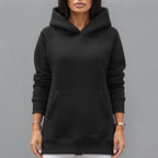 Front close-up of the Wilhelmine oversized side-slit hoodie in black, highlighting the cozy hood, soft fabric, relaxed fit, and stylish front details.