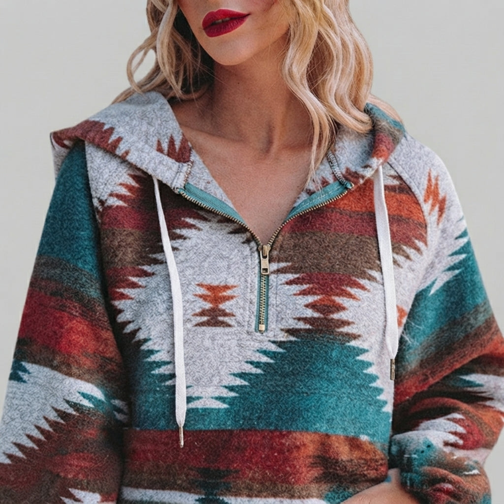 Front close-up of the red Zephira Hoodie Aztec-Print Half-Zip, highlighting the Aztec print, half-zip neckline, attached hood, and detailed fabric pattern.