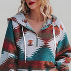Front close-up of the red Zephira Hoodie Aztec-Print Half-Zip, highlighting the Aztec print, half-zip neckline, attached hood, and detailed fabric pattern.