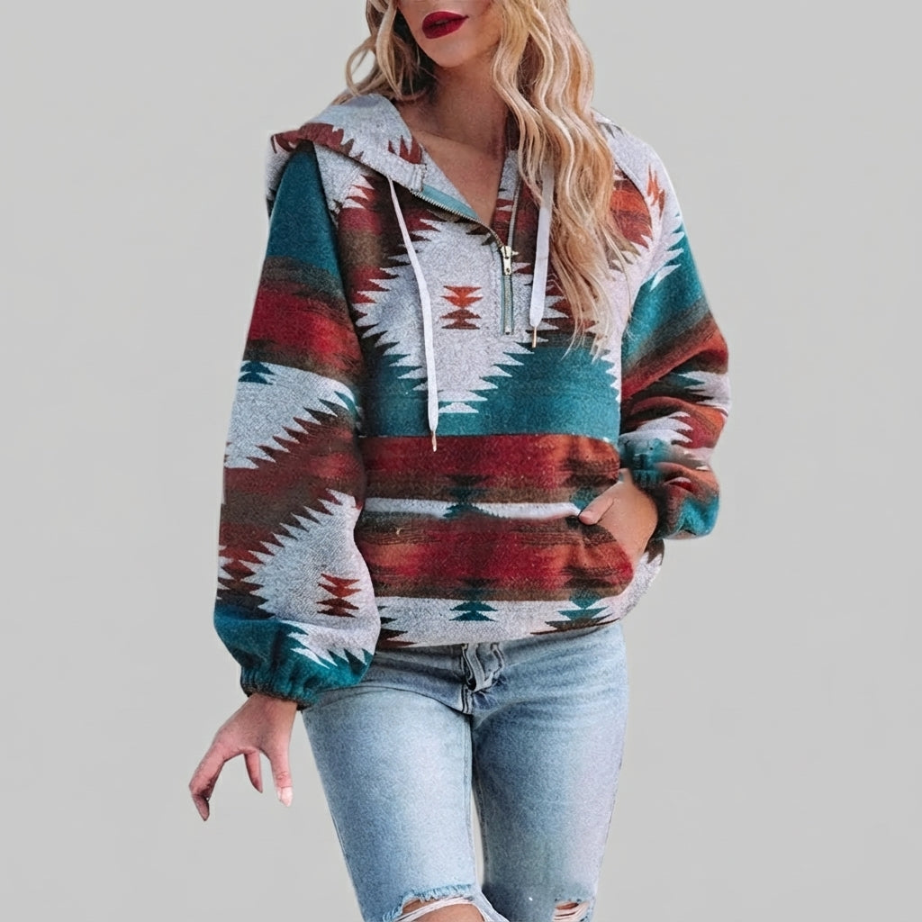 Front view of the red Zephira Hoodie Aztec-Print Half-Zip, featuring a bold Aztec print, attached hood, long sleeves, and half-zip front closure.