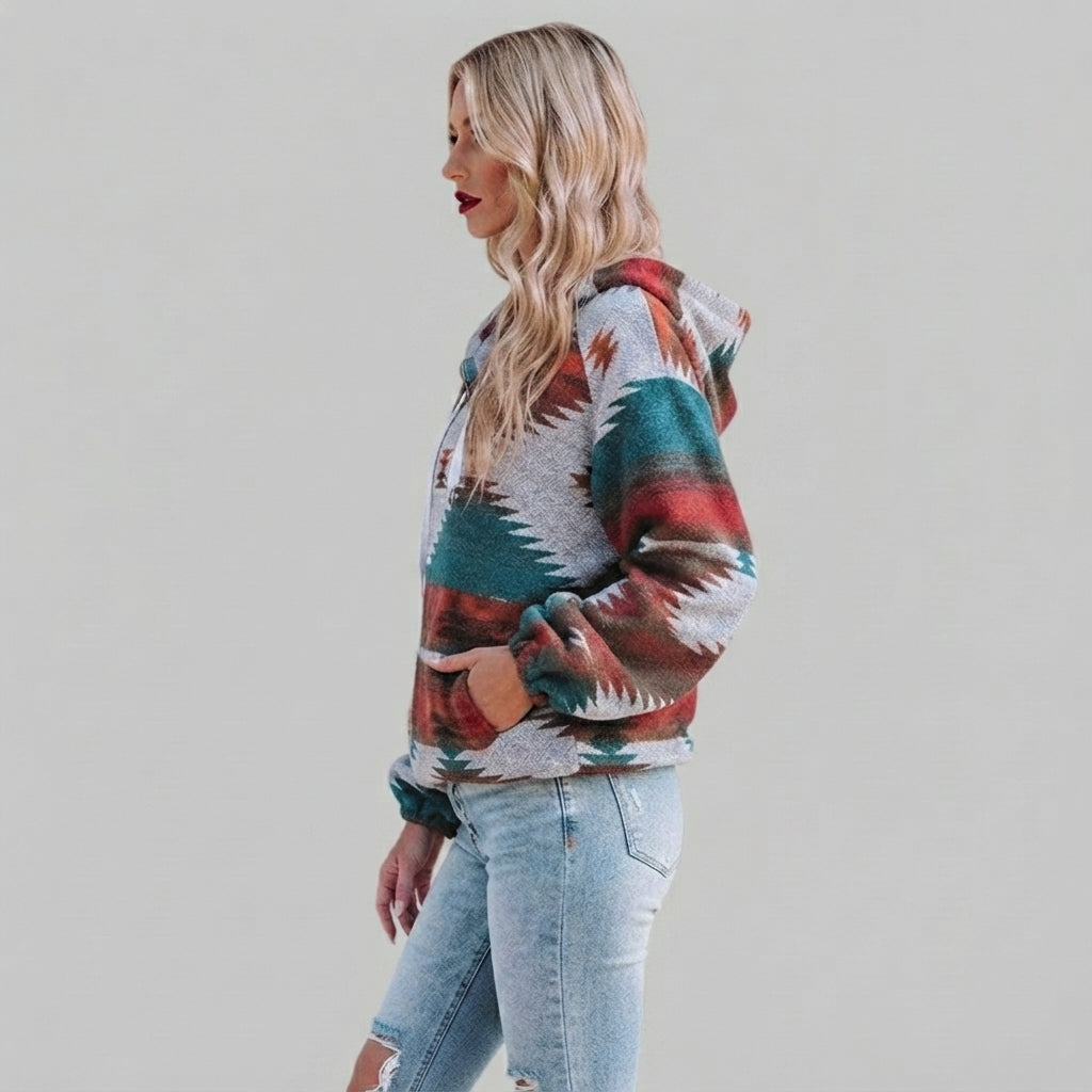 Side view of the red Zephira Hoodie Aztec-Print Half-Zip, showcasing its Aztec print, relaxed fit, attached hood, long sleeves, and half-zip design.