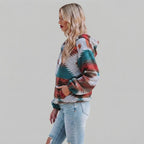 Side view of the red Zephira Hoodie Aztec-Print Half-Zip, showcasing its Aztec print, relaxed fit, attached hood, long sleeves, and half-zip design.