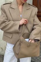 Adele Beige close-up of the wide notched lapels, shoulder epaulettes, and flap pocket.