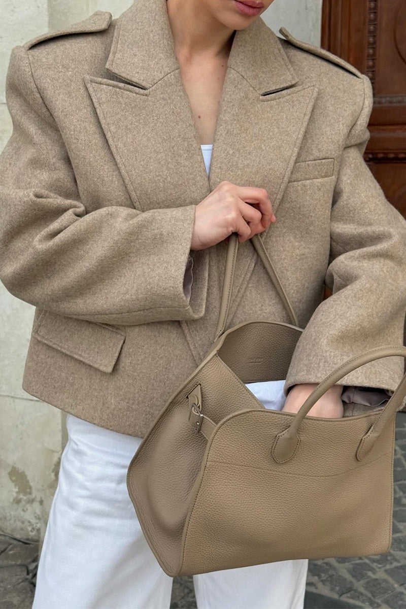 Adele Beige close-up of the wide notched lapels, shoulder epaulettes, and flap pocket.