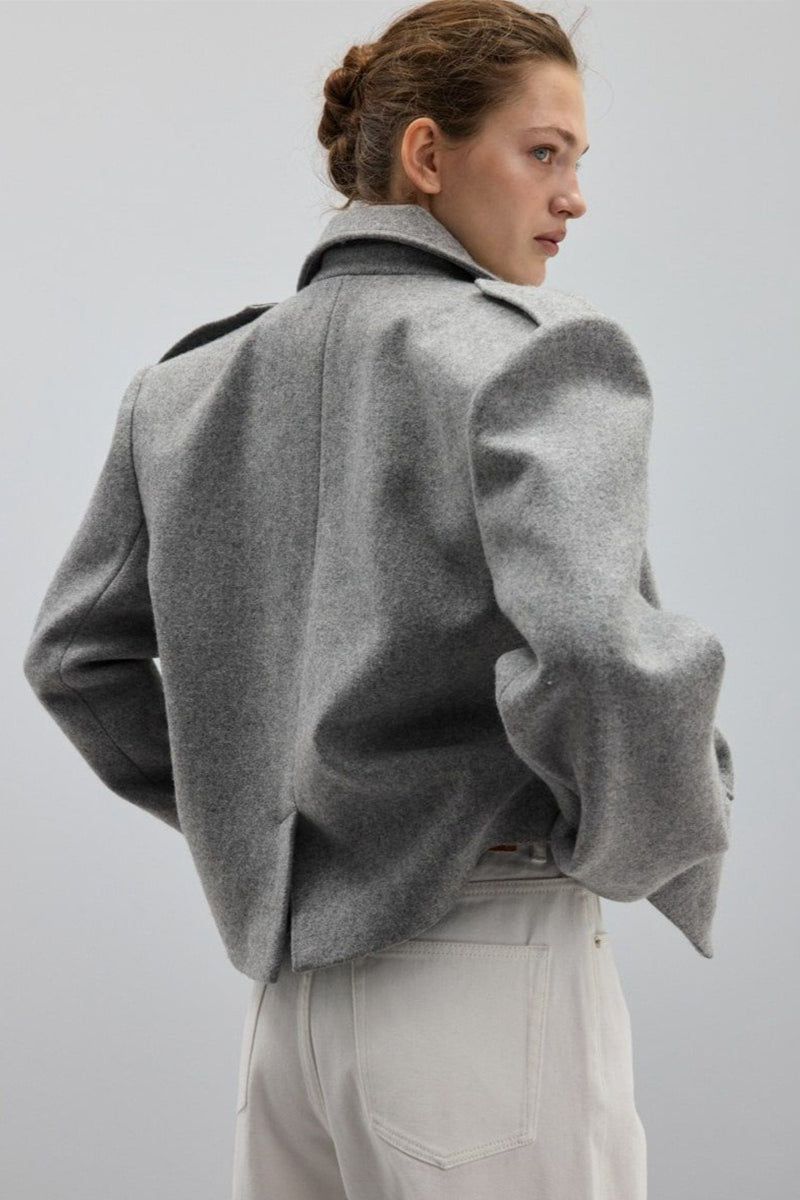Adele Gray short jacket from the back showing the structured shoulders and back hem vent.