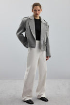 Adele Gray short jacket styled with white wide-leg jeans and black flats.