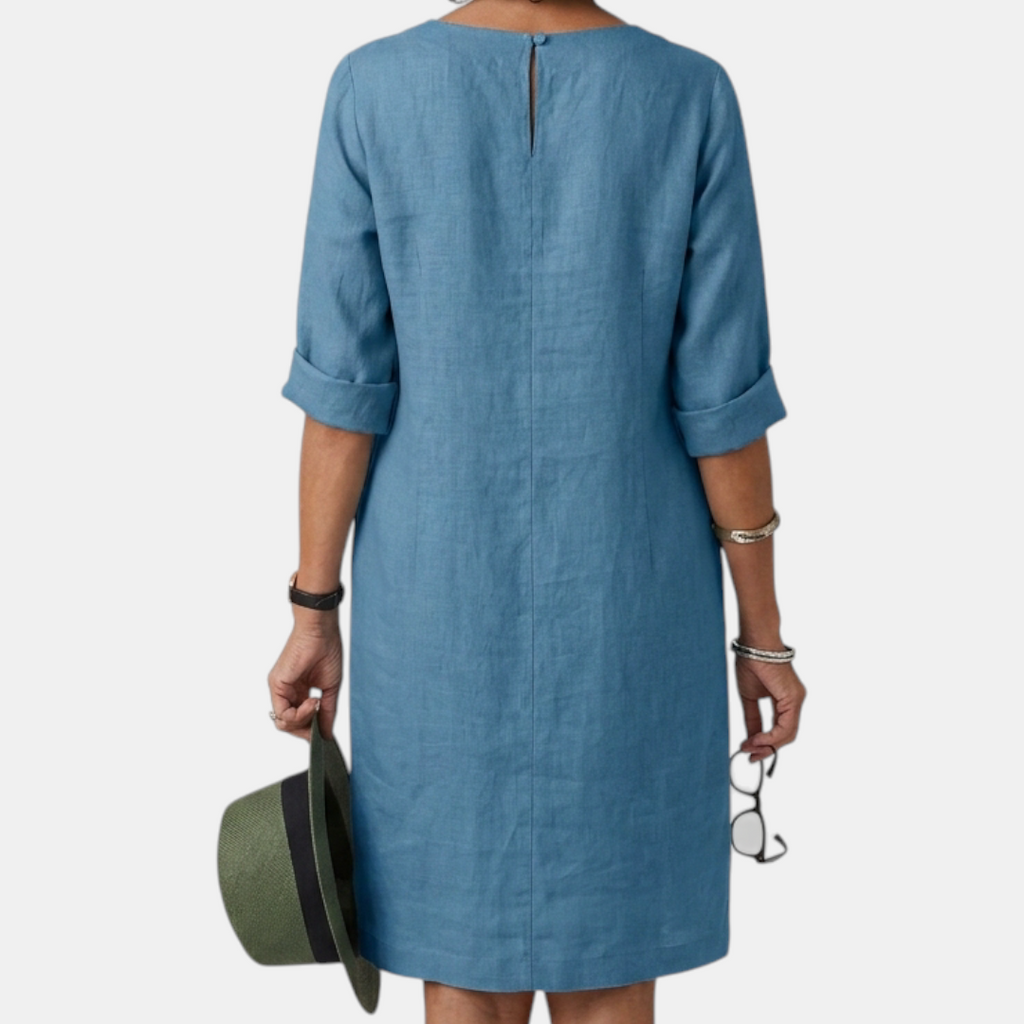Back view of the Adele Shift Dress Lightweight V-Neck Half-Sleeve in blue, highlighting the clean back design, relaxed silhouette, and lightweight fabric. Designed by Bella Hudson.